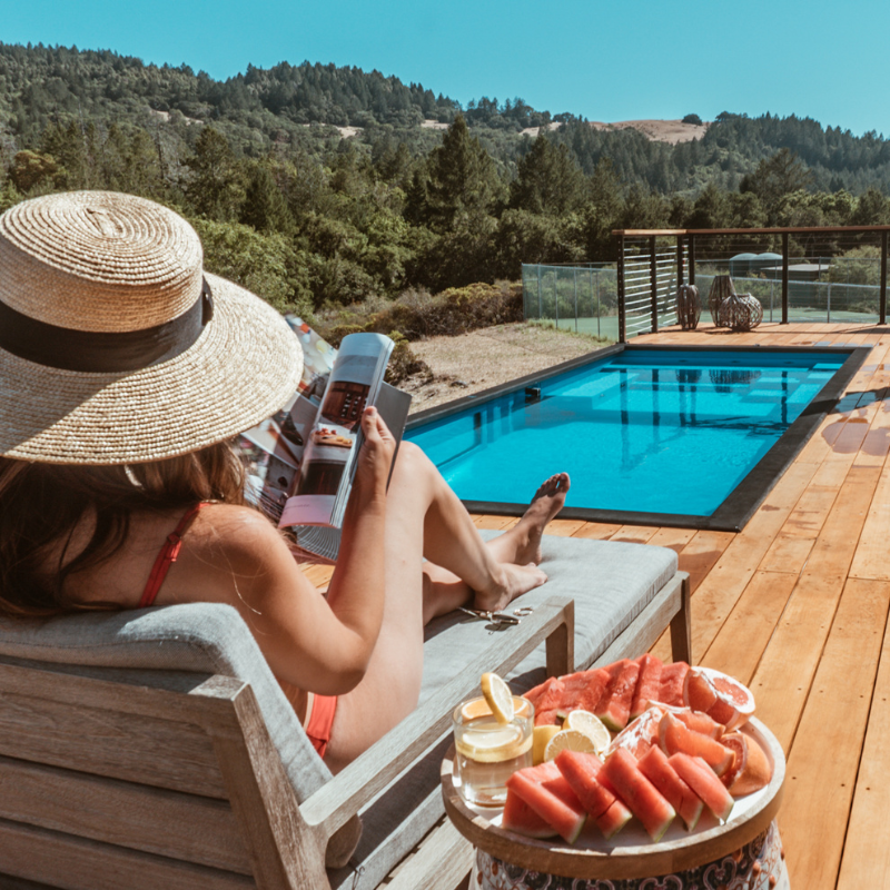 Woman Reading a Book on a Lounge Chair, Surrounded by Breathtaking Views at a Napa Valley Luxury Vacation Rental