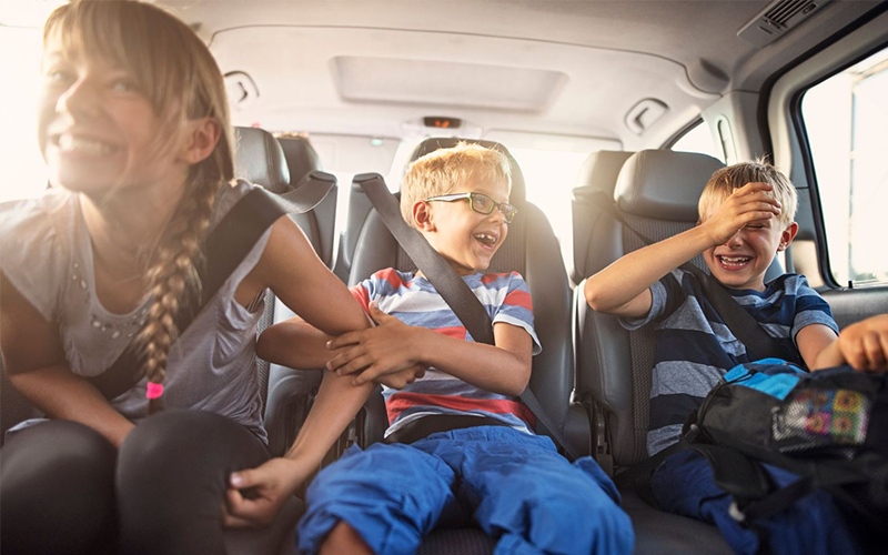Excited children in a car, embarking on a fun-filled trip to Napa Valley's activities